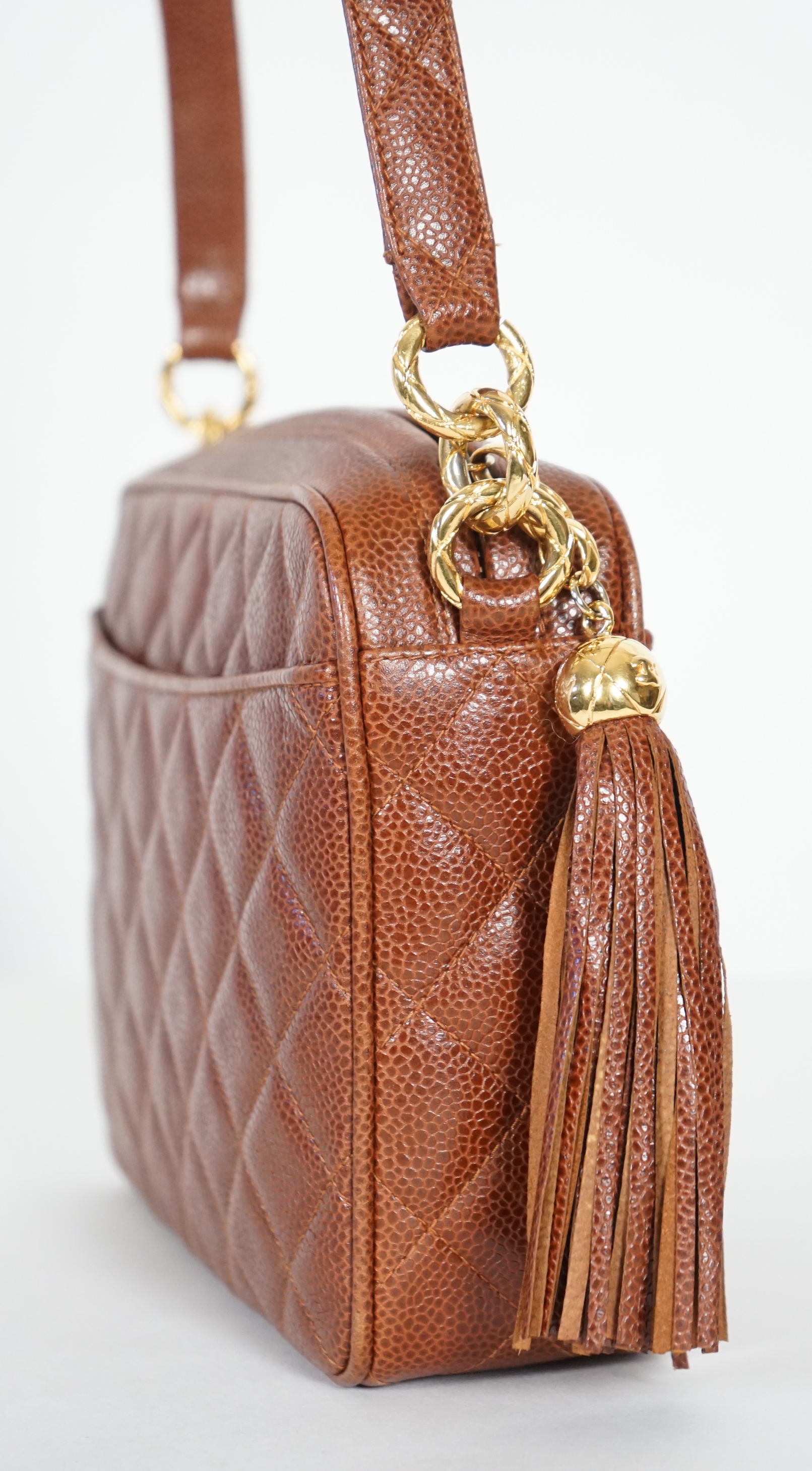 A Chanel vintage camera bag with tassel in brown quilted calf skin, width 23cm, height 27cm, depth 27cm